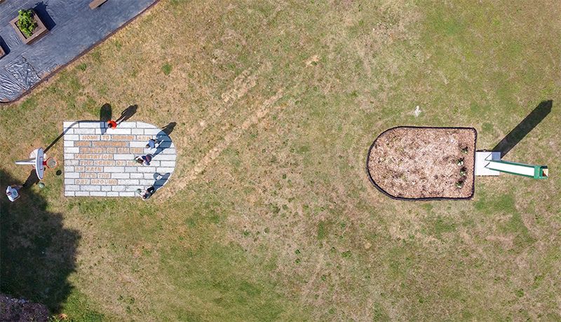 An aerial photo of folks playing on the experimental concrete basketball key, the garden key and the swift tower.